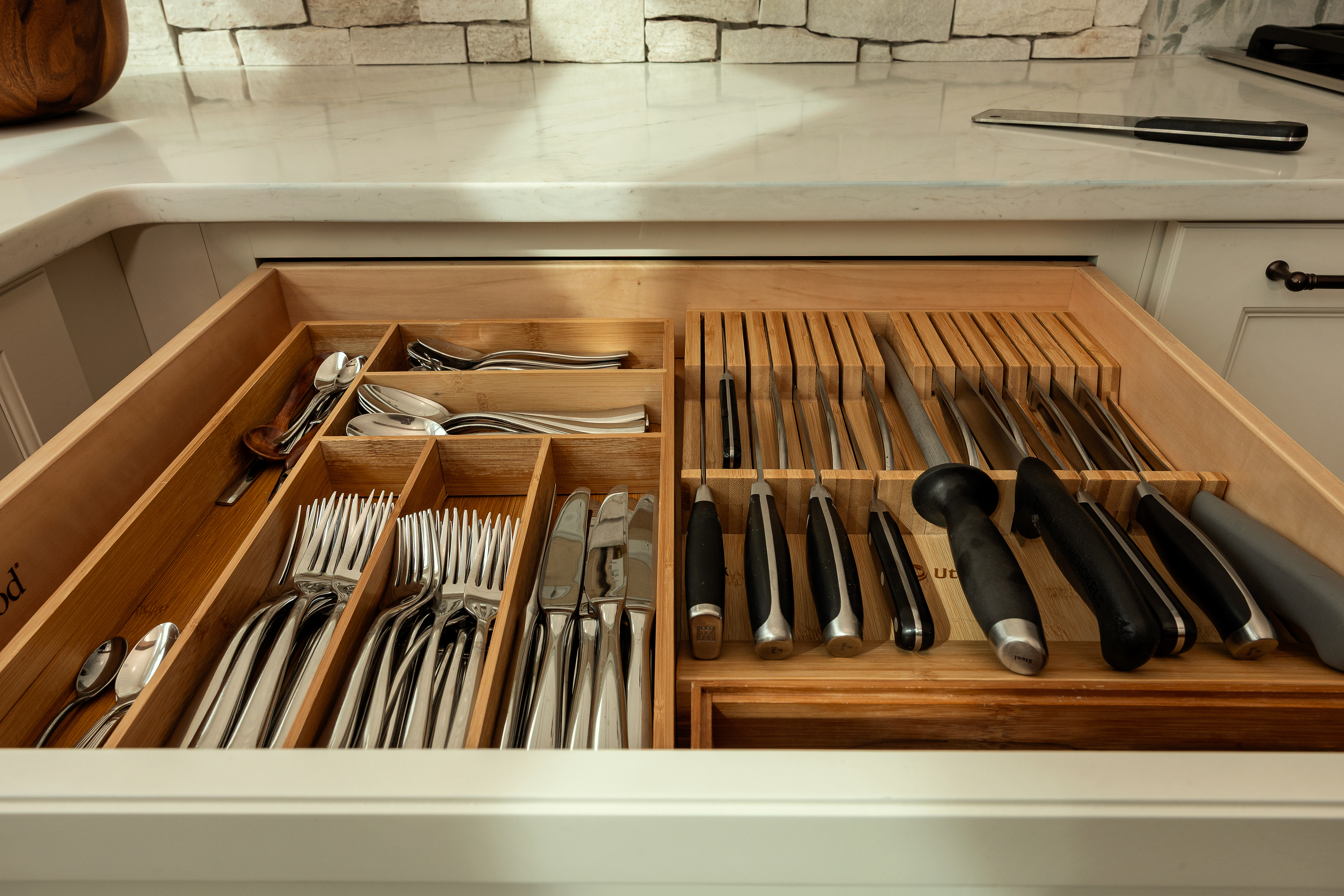 Open drawer with cutlery and knife insert — kitchen detail photography